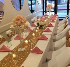 the tables are set with pink and gold linens