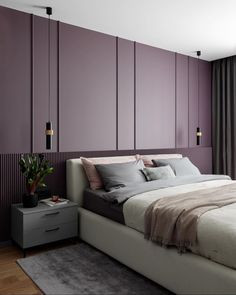 a large bed sitting next to a window in a room with wooden floors and purple walls