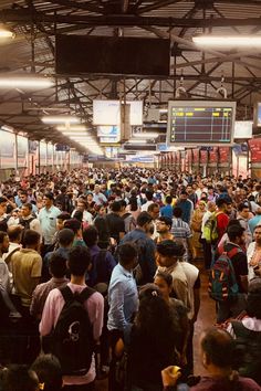 a large group of people standing in a train station