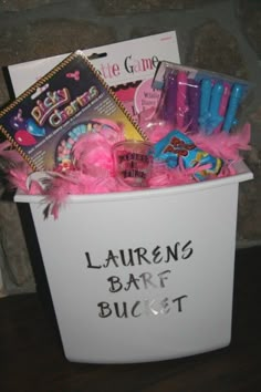 a white basket filled with lots of different types of items in it and the words lauren's barf bucket