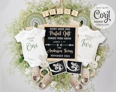 the baby announcement is displayed in front of a wreath with two onesuits and an infant's t - shirt