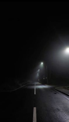 an empty street at night in the dark