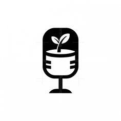 a black and white image of a microphone with a plant growing out of the top