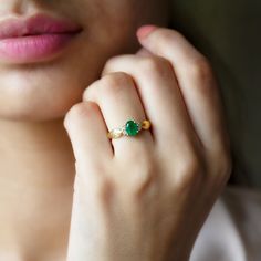 Product Details Amidst gleaming round diamond sits majestically an oval lush green emerald in this solitaire ring that looks splendid with its unrivalled allure. Secured in a prong setting, the emerald and diamond impeccably complement each other in the most eye-catching way. The pinched shank is the perfect classic addition to this dazzling piece. Wear it as stand-alone jewelry to create the maximum effect. Product Information SKU SHP-RINGS0721117454 Width 7 mm Height 3.8 mm Weight 2.24 gm (Approximate) EMERALD INFORMATION No.of Stones 1 Pieces Total Weight 0.72 Carat (Approximate) Dimension(approx) Oval-5X7 mm-1 Pcs Color Green Cut Brilliant Shape Oval Setting Type Accent Quality Grade AAA DIAMOND INFORMATION No.of Stones 4 Pieces Total Weight 0.14 Carat (Approximate) Dimension(approx) R Emerald Ring Designs For Women, Emerald Ring Design, Emerald Solitaire Engagement Ring, Nepal Bracelets, Emerald Ring Gold, Gold Rings Fashion, Rings Fashion, Ring With Diamond, 18k Yellow Gold Ring