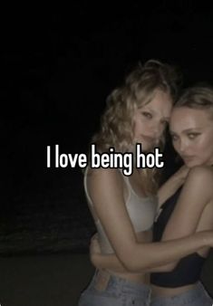 two women hugging each other with the words i love being hot in front of them