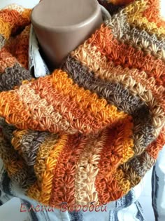 an orange, brown and white scarf on a mannequin