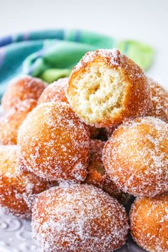 powdered sugar covered donuts on a plate