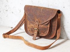 Leather Saddle Bag 12 Inch - If you are looking for a reliable and classic bag, the leather saddlebag is the perfect bag for you. Whether you are going on a shopping trip or exploring a new city, the saddlebag won't disappoint!  Please note that the current stock of saddle bags has brown stitching, not white as photographed.    * Classic vintage bag  * Fits daily essentials   * Comfortable arm strap   * External front pocket Leather saddle bag size: W30cm x H22 x D7 (12 x 8.5 x 3) Classic Bags, Vintage Bag, Saddle Bag, New City, Daily Essentials, Satchel Bag, Everyday Bag, Perfect Bag