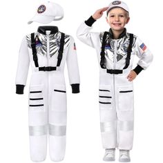 a young boy wearing an astronaut suit and hat, standing in front of a white background