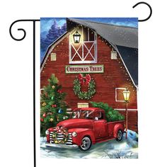 a red truck parked in front of a barn with a christmas tree on the roof