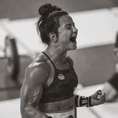 a woman with her mouth wide open in the gym