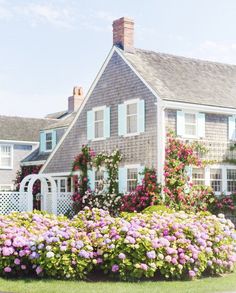 a house with many flowers in front of it