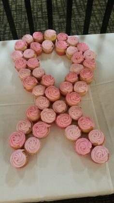 cupcakes arranged in the shape of an x on a table