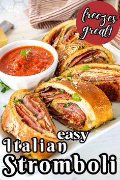 a white plate topped with sandwiches next to a bowl of tomato sauce