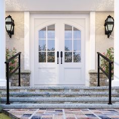 a white front door with two sidelights next to some steps and flowers on either side