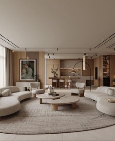 a living room with white couches and round coffee table in front of a large window