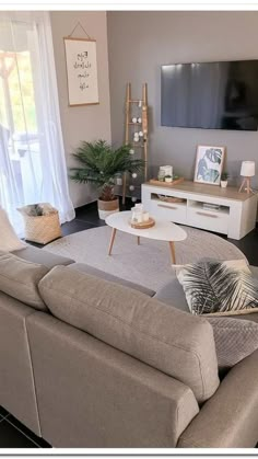 a living room filled with furniture and a flat screen tv mounted to the side of a wall