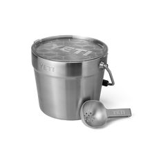 a stainless steel ice bucket and scooper with the word yeti printed on it