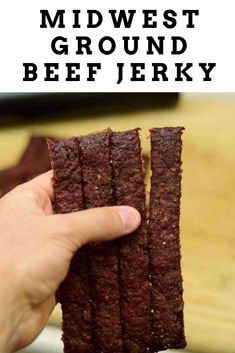 a hand holding up some kind of brownie with the words mid west ground beef jerry