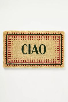 a door mat with the word ciao on it in black and red lettering, against a white background