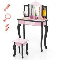 a pink and black vanity with mirror, stool and hairbrush on the table next to it