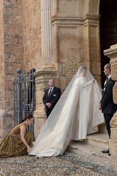 the bride and groom are getting ready to walk down the stairs