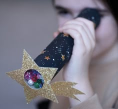 a woman talking on a cell phone while holding a star shaped object