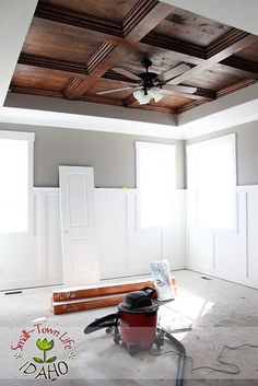 a room that is being remodeled with the ceiling painted white and wood trimmings