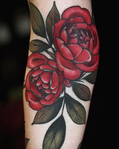 a red rose tattoo on the arm