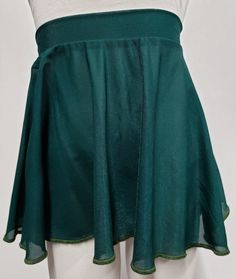 These pull on circle dance skirts are perfect for your cute little dancer! The Color of the skirt is dark green. Pull on circle Skirts are a great fast way to get the skirt on and go! The skirts have a flattering hemline and a sense of movement that is fun for your little dancers to wear. They elongate the legs and look great on everyone! Dancers love this skirt because it is short enough to show correct technique. You'll love it for the graceful, flowing shape that shows off your dancers' legs! Green Full Skirt For Party, Green Fitted Tiered Skirt, Green Stretch Flared Skirt, Green Flared Skirt With Elastic Waistband, Green Stretch Lined Swim Skirt, Green Lined Skirted Bottoms, Fitted Green Skirt With Elastic Waistband, Green Stretch Mini Skirt With Lined Skirt, Green Pleated Short Skirt