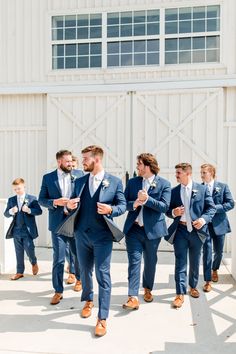 a group of men in suits and ties walking together