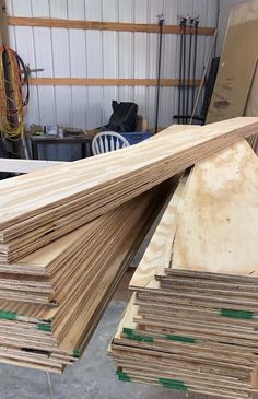 several pieces of plywood are stacked on top of each other in a workshop area