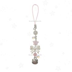 a key chain with charms attached to it's end and a bow on top