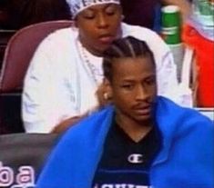 two women sitting next to each other at a basketball game