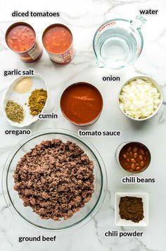 the ingredients to make chili sauce are shown in separate bowls on a marble countertop