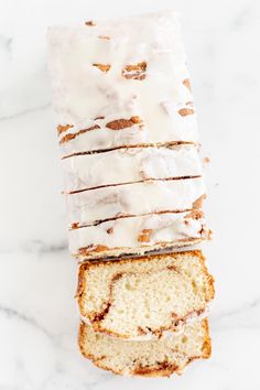 a loaf of glazed pound cake sitting on top of a marble counter