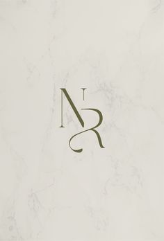 the letter n is made up of letters and numbers in green on a white marble background