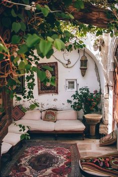 a living room filled with furniture and lots of greenery