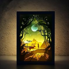 a paper cut artwork depicting a forest scene