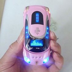 a person holding a pink cell phone with blue lights