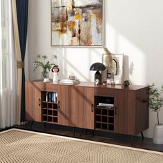 a living room with a large painting on the wall and a wooden sideboard in front of it