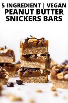 five ingredient vegan peanut butter snickkers bars stacked on top of each other