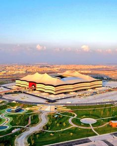 an aerial view of a large building in the middle of a field