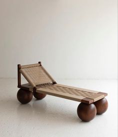 a bed made out of wood with wheels on the bottom and one foot in the middle