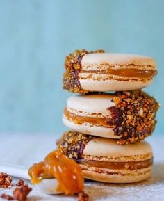 three donuts stacked on top of each other with peanut butter drizzled on them