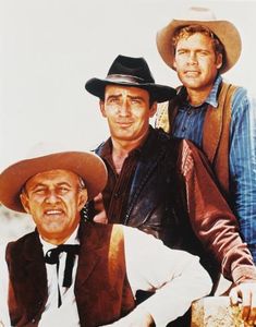 three men in cowboy hats posing for a photo