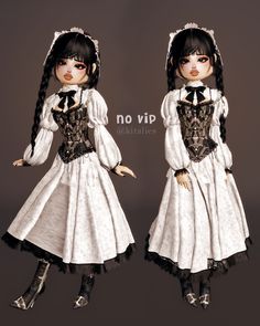 two dolls dressed in white and black clothing, one wearing a dress with long sleeves