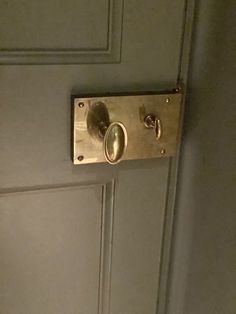 an open door with two knobs and a handle on the front side of it