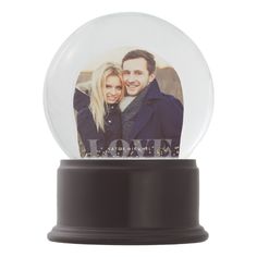 a snow globe with an image of a couple in it