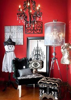 a living room with red walls and chandelier